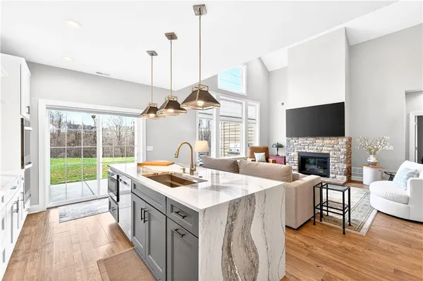 a very nice looking living room with a large window a flat screen tv and a fireplace