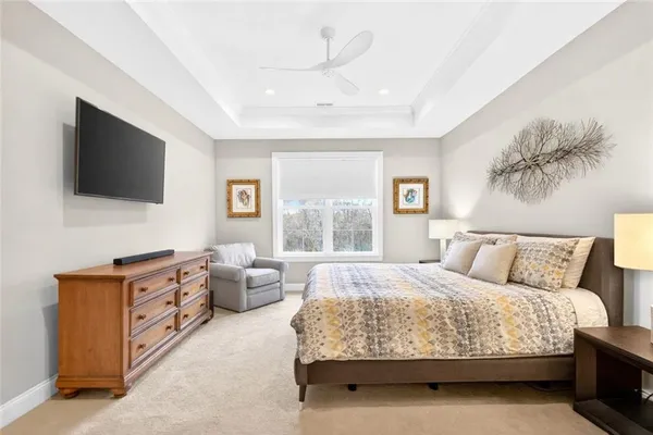 a bedroom with a large bed and a flat screen tv