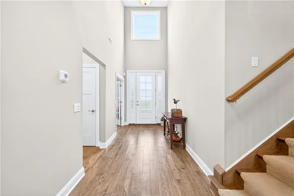 a view of hallway with wooden floor and stairs