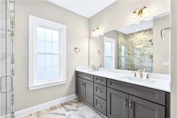 a bathroom with a double vanity sink mirror and double