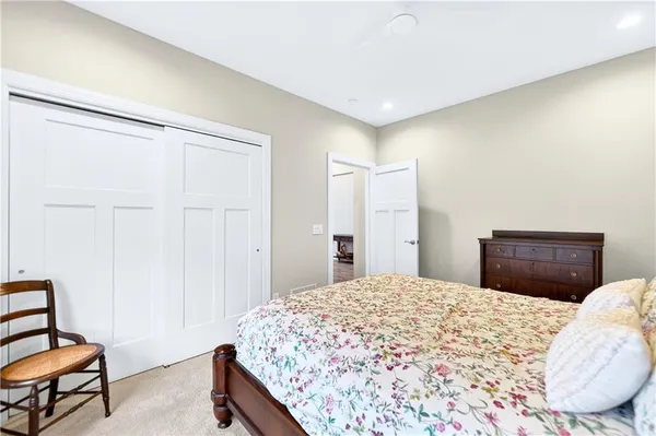 a bedroom with a bed and a dresser