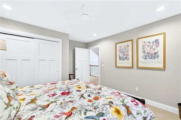 a bedroom with bed and painting on the wall