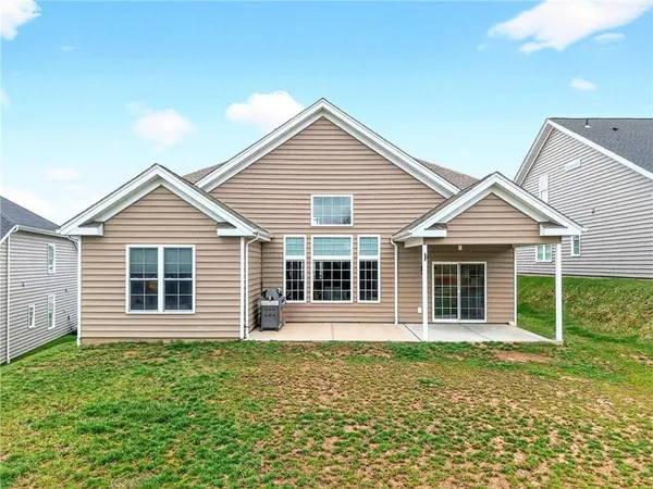a view of a house with a yard and large window