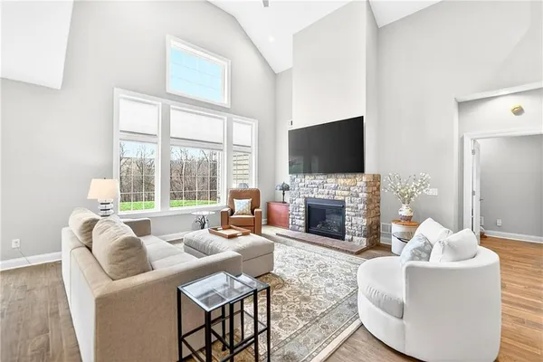a living room with fireplace furniture and a flat screen tv