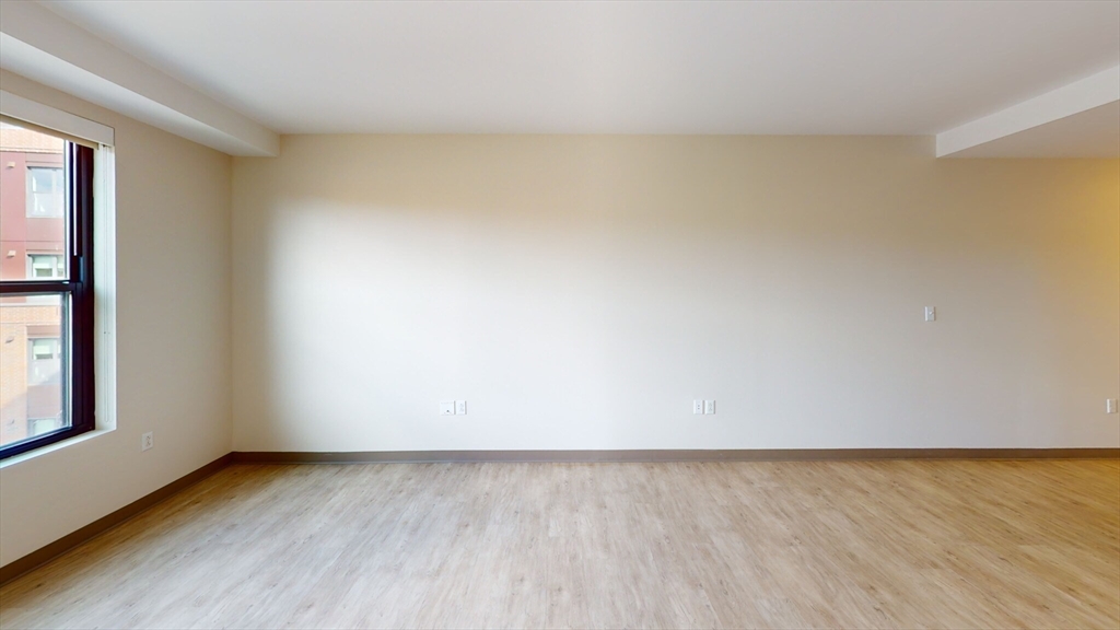 225 Centre Street, Unit 716 Boston, MA 02119 - Photo 7 of 9 a view of an empty room and window
