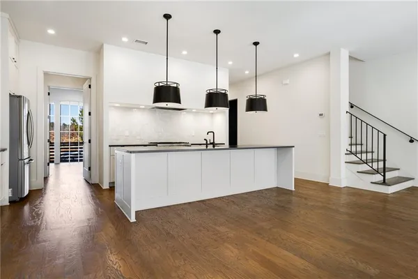 a large kitchen with stainless steel appliances kitchen island a sink and a stove top oven