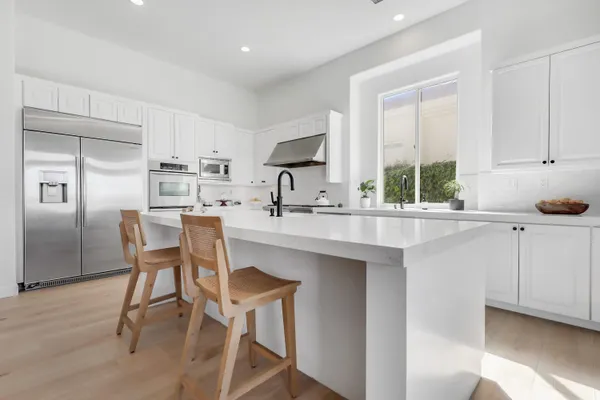 a kitchen with stainless steel appliances a sink stove and cabinets