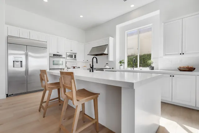 a kitchen with stainless steel appliances a sink stove and cabinets