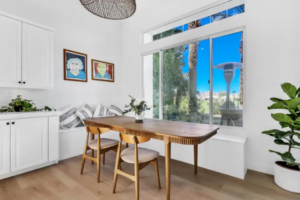 a dining room with furniture and wooden floor