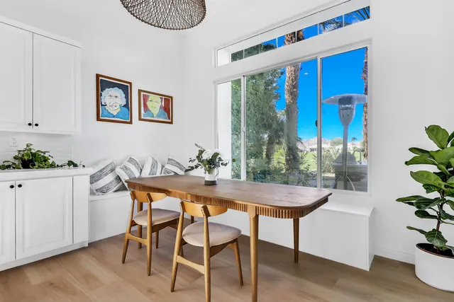 a dining room with furniture and wooden floor