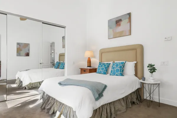 a bedroom with a bed and a table