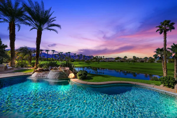 a view of swimming pool outdoor seating and city view