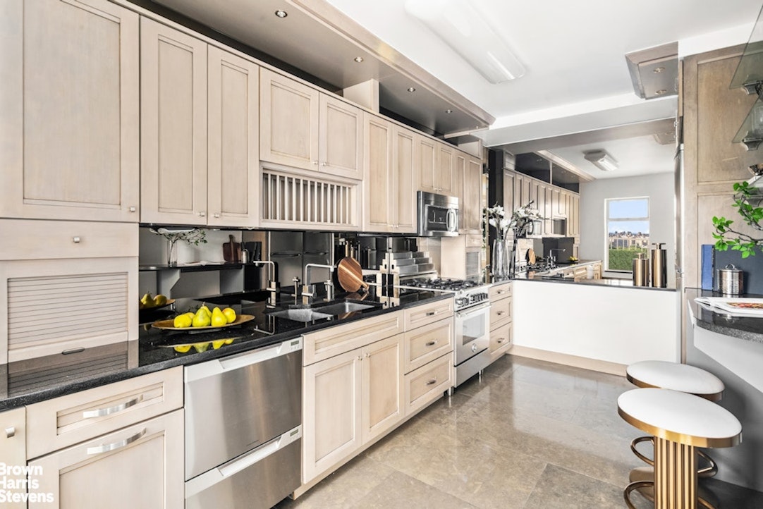 880 5th Avenue, Unit PHF Manhattan, NY 10021 - Photo 3 of 16 a kitchen with stainless steel appliances a white cabinets and a counter space
