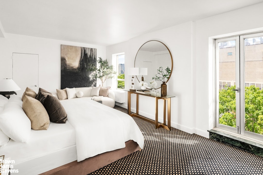 880 5th Avenue, Unit PHF Manhattan, NY 10021 - Photo 5 of 16 a bedroom with a bed a mirror and a large window with outer view