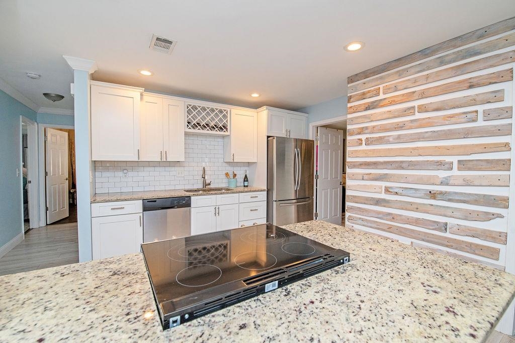 436 Orchis Road St. Augustine, FL 32086 - Photo 16 of 39 a large kitchen with kitchen island granite countertop a refrigerator and cabinets