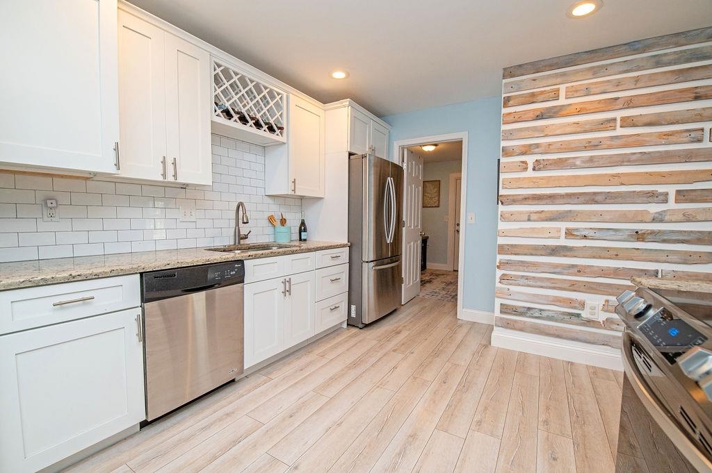 436 Orchis Road St. Augustine, FL 32086 - Photo 17 of 39 a kitchen with white cabinets and white appliances