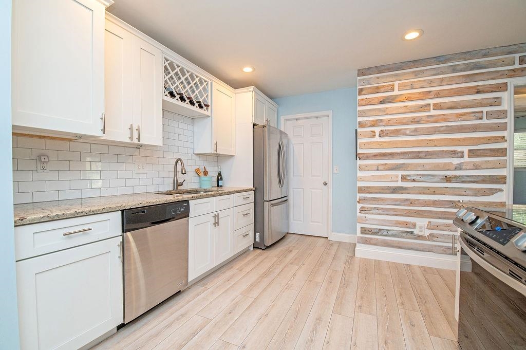 436 Orchis Road St. Augustine, FL 32086 - Photo 19 of 39 a kitchen with a refrigerator and white cabinets