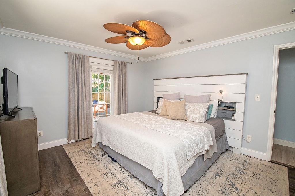 436 Orchis Road St. Augustine, FL 32086 - Photo 27 of 39 a bedroom with a large bed and a chandelier