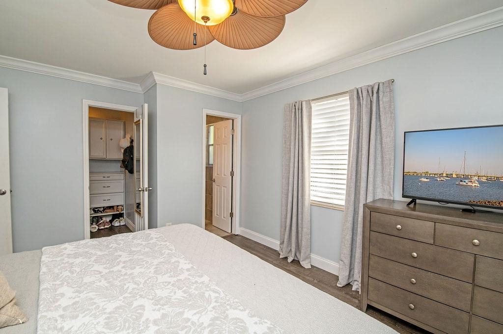 436 Orchis Road St. Augustine, FL 32086 - Photo 28 of 39 a bedroom with a bed and chandelier with mirror