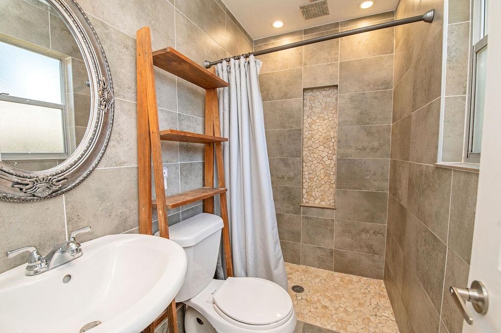 436 Orchis Road St. Augustine, FL 32086 - Photo 29 of 39 a bathroom with a sink toilet and shower
