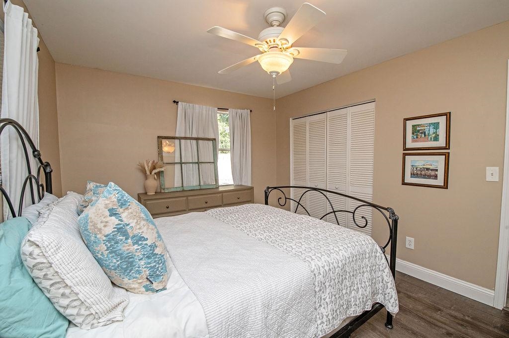 436 Orchis Road St. Augustine, FL 32086 - Photo 32 of 39 a bedroom with a large bed and a chandelier