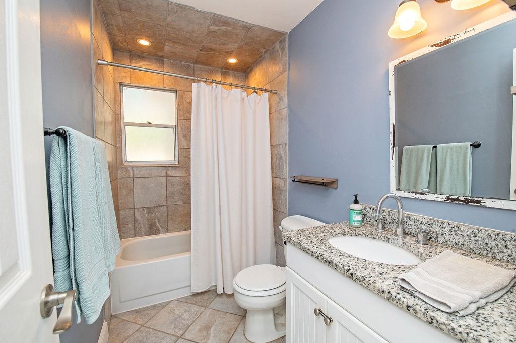 436 Orchis Road St. Augustine, FL 32086 - Photo 33 of 39 a bathroom with a granite countertop sink toilet and shower