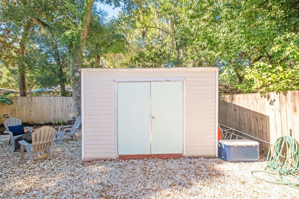436 Orchis Road St. Augustine, FL 32086 - Photo 5 of 39 a backyard of a house with chairs and a tree