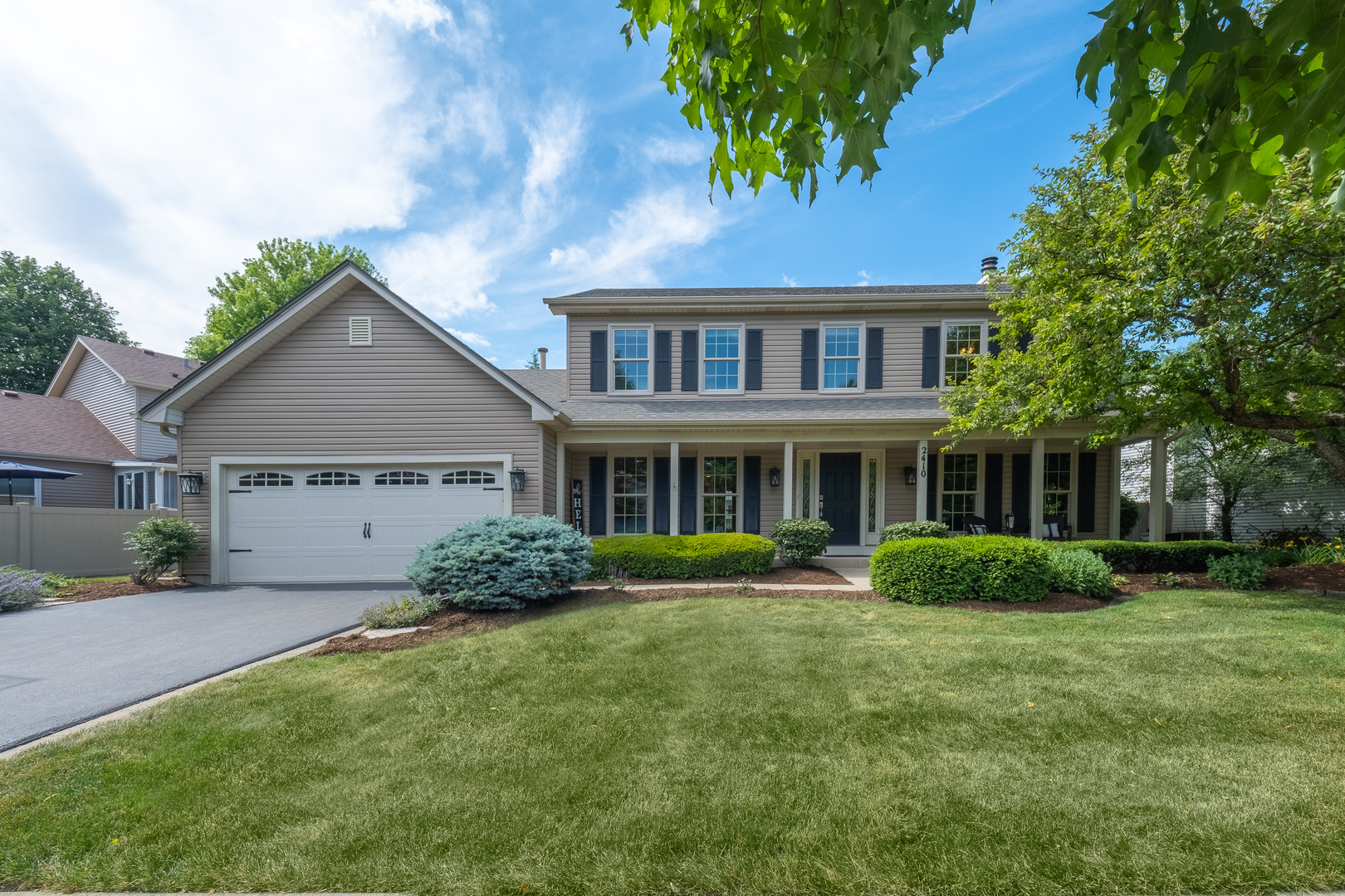 2410 Highland Road Geneva, IL 60134 - Photo 1 of 26 a front view of a house with a garden