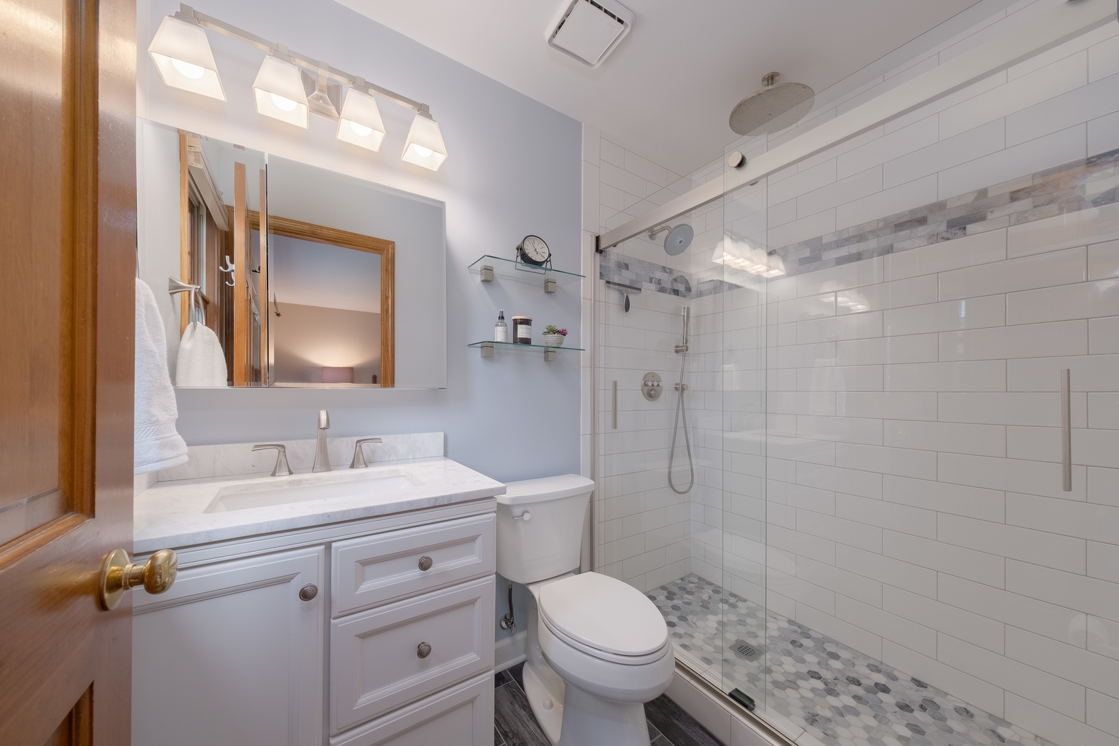 2410 Highland Road Geneva, IL 60134 - Photo 18 of 26 a bathroom with a double vanity sink toilet mirror and shower