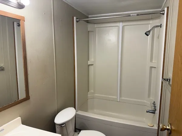 a bathroom with a shower and a toilet