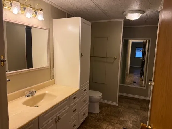 a bathroom with a granite countertop sink toilet and shower
