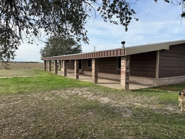 a view of house with backyard