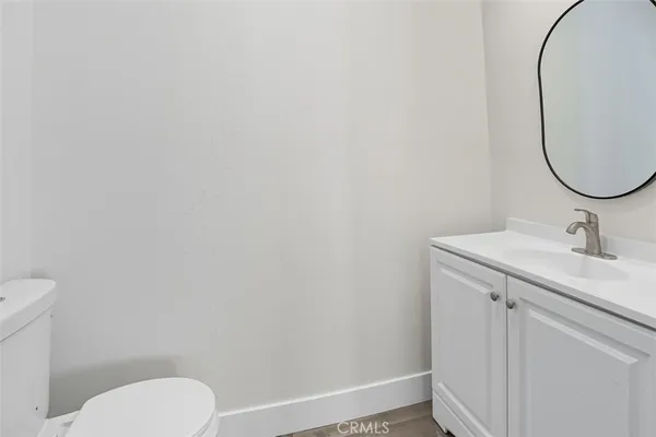 wooden floor in a hall with an entryway and a window