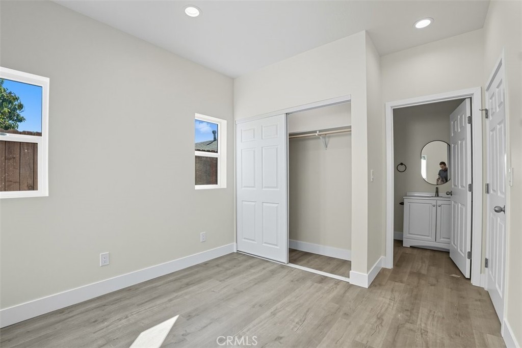 19258 Strathern Street Reseda, CA 91335 - Photo 13 of 36 wooden floor in a hall with an entryway and a window