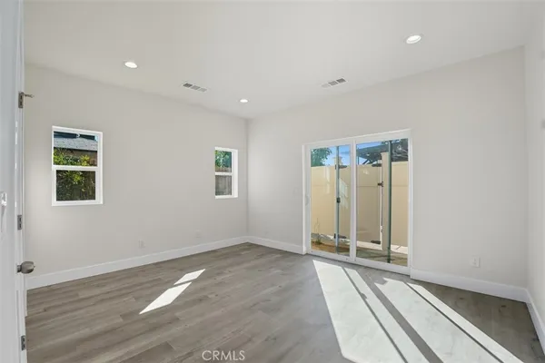 a view of a room with wooden floor