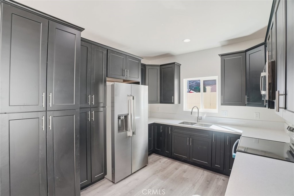 19258 Strathern Street Reseda, CA 91335 - Photo 19 of 36 a kitchen with stainless steel appliances a refrigerator and a sink