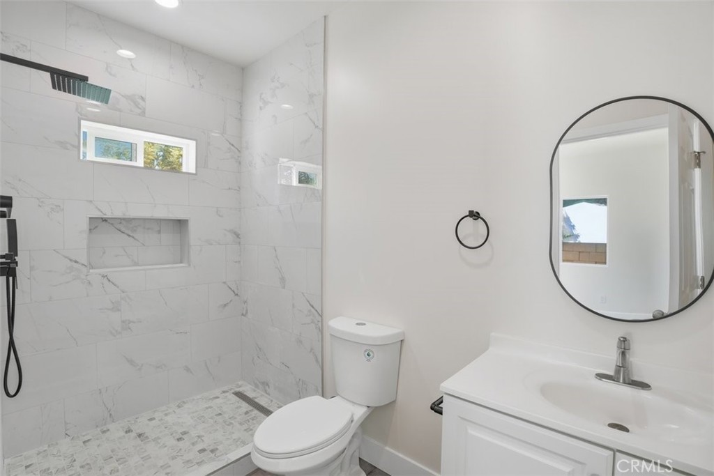 19258 Strathern Street Reseda, CA 91335 - Photo 25 of 36 a bathroom with a sink a toilet and a mirror