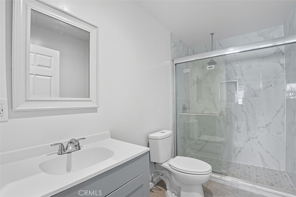 19258 Strathern Street Reseda, CA 91335 - Photo 5 of 36 a bathroom with a sink a toilet and shower