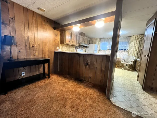 a view of hallway with a large mirror and a sink