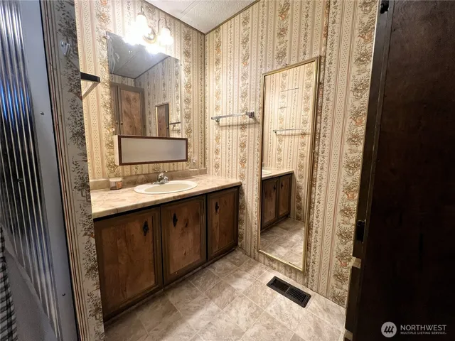a bathroom with a double vanity sink and a mirror