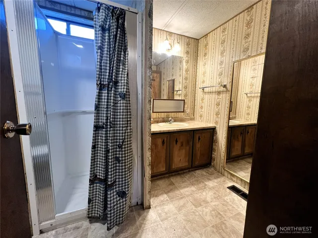 a bathroom with a shower and a sink