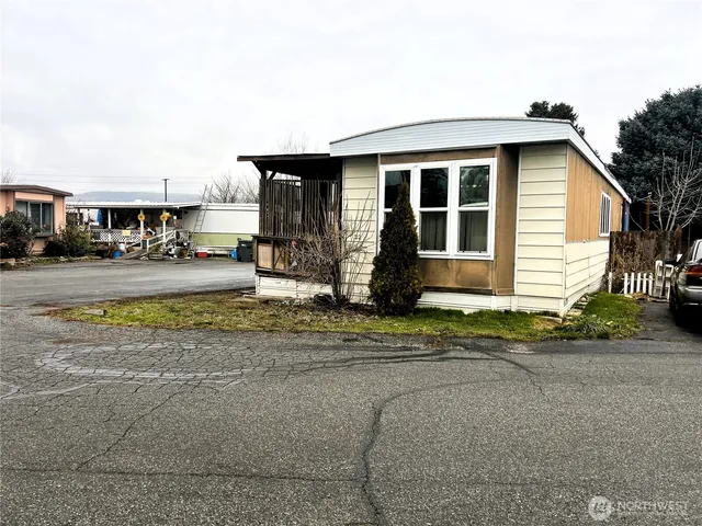 a front view of a house with a yard and sitting area