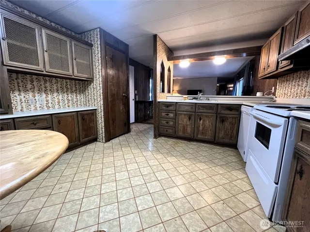 a kitchen with stainless steel appliances granite countertop a sink stove and cabinets