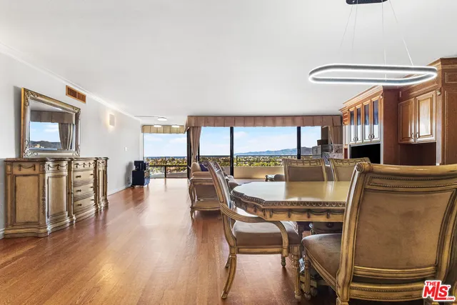 a dining room with furniture window and wooden floor