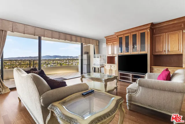 a living room with furniture and a floor to ceiling window
