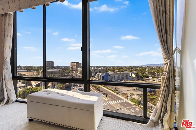 a view of hallway with wooden floor and a living room