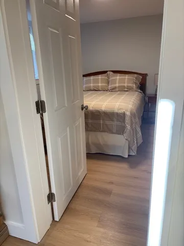 a bedroom with a bed and a mirror