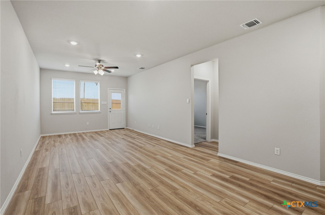 1126 Stone Vly Road, Unit B Temple, TX 76502 - Photo 12 of 26 wooden floor in an empty room with a window