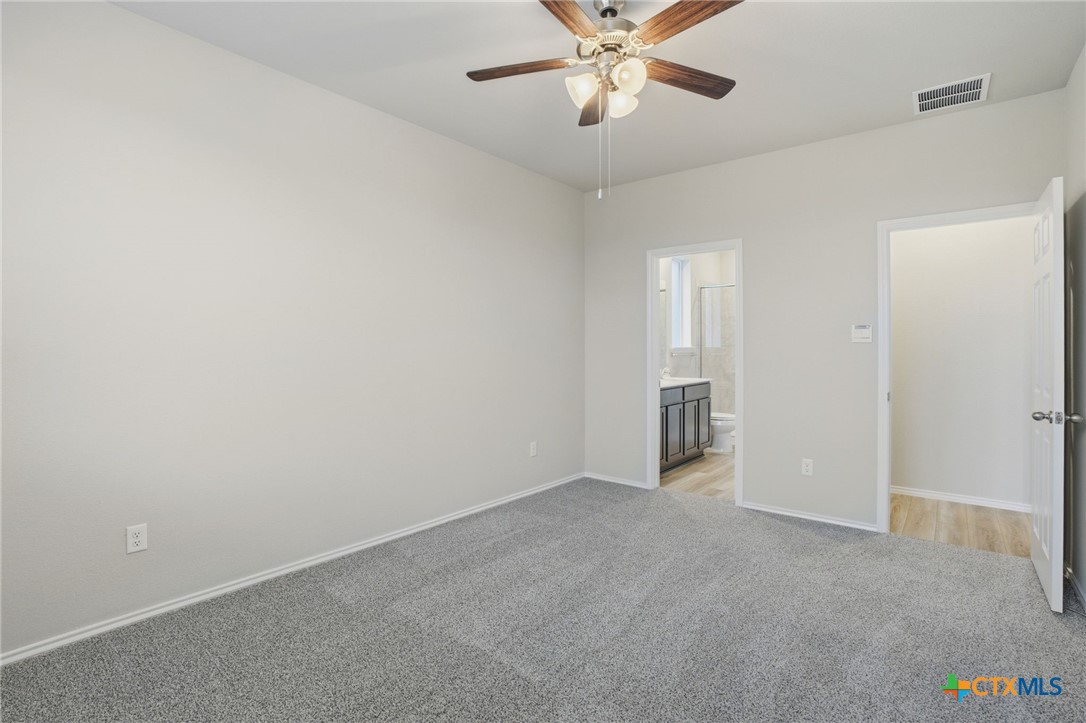 1126 Stone Vly Road, Unit B Temple, TX 76502 - Photo 20 of 26 a view of an empty room with a chandelier fan