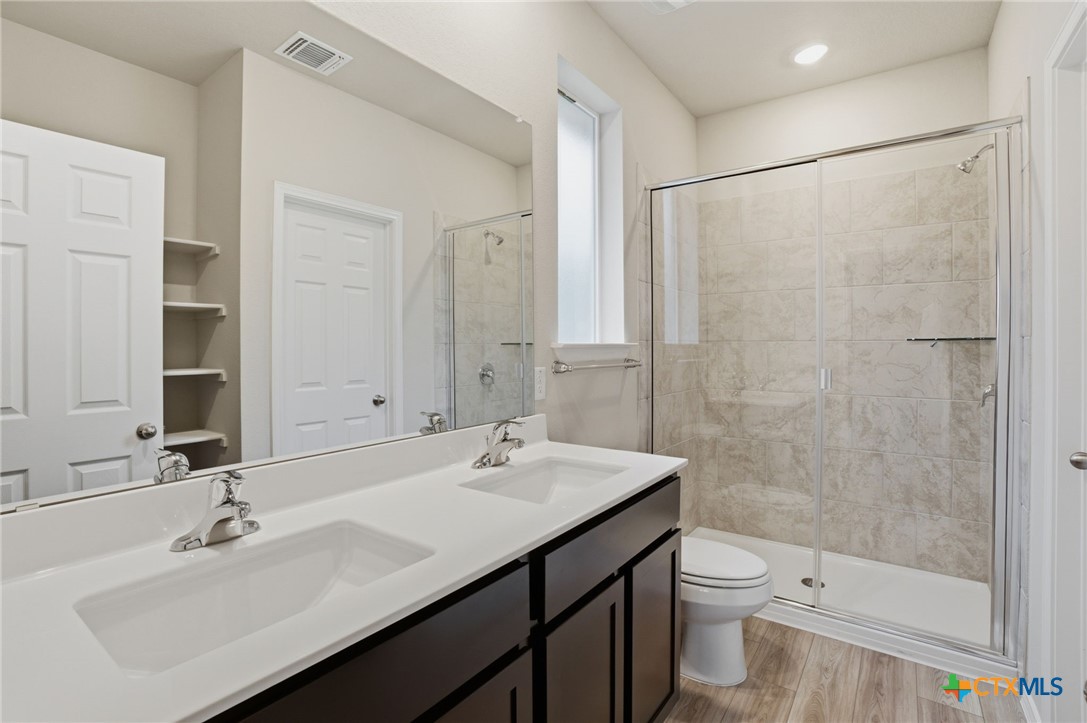 1126 Stone Vly Road, Unit B Temple, TX 76502 - Photo 21 of 26 a bathroom with a sink toilet a mirror and shower